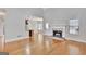 Spacious living room featuring hardwood floors and a cozy fireplace at 90 Barrington Grange Dr, Sharpsburg, GA 30277
