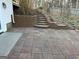 Outdoor patio with retaining wall and tiered steps leading up to backyard at 90 Barrington Grange Dr, Sharpsburg, GA 30277