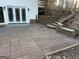 Outdoor patio with french doors leading into home and retaining wall with tiered steps at 90 Barrington Grange Dr, Sharpsburg, GA 30277