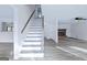 Modern staircase with gray railing and white risers at 115 Cypress Ct, Fayetteville, GA 30214