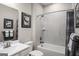 Well-lit bathroom with tub shower, featuring sleek fixtures and neutral color palette at 2070 Fortuna St, Lawrenceville, GA 30046
