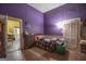 Small bedroom with purple walls and wood floors at 613 Mc Donald Se St, Atlanta, GA 30312