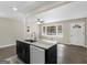 Open-concept kitchen with granite island and view into living area at 1088 Lloyd Dr, Forest Park, GA 30297