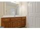 Bathroom with wood vanity, single sink, and mirror at 168 Robson Trl, Mcdonough, GA 30252