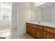 Clean bathroom with wood vanity, single sink, and large mirror at 168 Robson Trl, Mcdonough, GA 30252