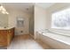 Bathroom with soaking tub and walk-in shower at 168 Robson Trl, Mcdonough, GA 30252
