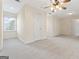 Spacious bedroom with carpeted floor, ceiling fan, and multiple closets at 168 Robson Trl, Mcdonough, GA 30252