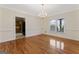 Spacious dining room featuring hardwood floors and a chandelier at 168 Robson Trl, Mcdonough, GA 30252