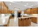 Eat-in kitchen boasts an island, stainless steel appliances, and wood cabinets at 168 Robson Trl, Mcdonough, GA 30252
