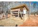 Wooden chicken coop with wire mesh and water source at 120 Dixie Trl, Covington, GA 30014