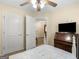 Well-lit bedroom with a desk, ceiling fan, and access to another room at 221 Prominent Loop, Mcdonough, GA 30253