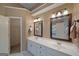 Elegant bathroom with double sinks, large mirror, and walk-in closet at 308 Bell Isle, Mcdonough, GA 30252