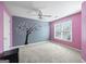 Charming bedroom with pink walls and a unique tree wall decal at 295 Camden Creek Ct, Lawrenceville, GA 30043