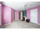Cozy bedroom with pink walls, ceiling fan and built-in desk area at 295 Camden Creek Ct, Lawrenceville, GA 30043