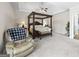 Bright bedroom featuring a king-size bed and comfortable armchair at 295 Camden Creek Ct, Lawrenceville, GA 30043