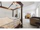 Spacious main bedroom with a large four-poster bed and sitting area at 295 Camden Creek Ct, Lawrenceville, GA 30043
