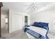 Bedroom with a blue comforter, double doors to the bathroom and carpet flooring at 295 Camden Creek Ct, Lawrenceville, GA 30043