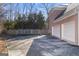 Two-car garage with a concrete driveway and wooden fence at 295 Camden Creek Ct, Lawrenceville, GA 30043