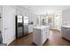 Eat-in kitchen with island, hardwood floors, and white cabinets at 295 Camden Creek Ct, Lawrenceville, GA 30043