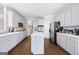 Modern kitchen featuring white cabinets, stainless steel appliances, and hardwood floors at 295 Camden Creek Ct, Lawrenceville, GA 30043