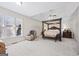 Large main bedroom with four-poster bed and carpeted floors at 295 Camden Creek Ct, Lawrenceville, GA 30043