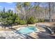 Kidney shaped pool with diving board, surrounded by a patio at 295 Camden Creek Ct, Lawrenceville, GA 30043