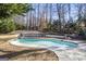Inviting kidney-shaped swimming pool surrounded by trees at 295 Camden Creek Ct, Lawrenceville, GA 30043