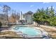 Home with inviting in-ground pool, spacious deck, and lush landscaping at 295 Camden Creek Ct, Lawrenceville, GA 30043