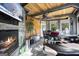 Sunroom features a fireplace, built-in seating, and wood ceilings at 295 Camden Creek Ct, Lawrenceville, GA 30043