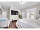 Main bedroom with large TV, double doors to backyard, and hardwood floors at 10 Plum Blossom Ln, Hampton, GA 30228