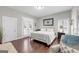 Bright bedroom with king-size bed, double doors to backyard, and hardwood floors at 10 Plum Blossom Ln, Hampton, GA 30228