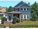 Two-story craftsman home with gray siding, brick accents, and a charming front porch at 10 Plum Blossom Ln, Hampton, GA 30228