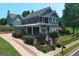 Charming two-story home featuring a cozy front porch and a well-manicured lawn and landscaped shrubbery at 10 Plum Blossom Ln, Hampton, GA 30228