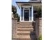 Black front door entrance with brick steps and landscaping at 10 Plum Blossom Ln, Hampton, GA 30228