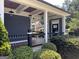 Inviting front porch with wooden flooring, black railings, and pendant lighting at 10 Plum Blossom Ln, Hampton, GA 30228