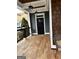 Front porch with wooden flooring, wicker chairs, and a black door at 10 Plum Blossom Ln, Hampton, GA 30228