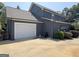 Attached garage with white door and driveway at 10 Plum Blossom Ln, Hampton, GA 30228