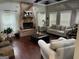 Spacious living room featuring a brick fireplace, hardwood floors, and ample natural light at 10 Plum Blossom Ln, Hampton, GA 30228