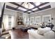 Spacious living room with a brick fireplace, exposed beams, and hardwood floors at 10 Plum Blossom Ln, Hampton, GA 30228