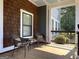 Inviting front porch with wicker chairs and a small table, perfect for relaxing outdoors at 10 Plum Blossom Ln, Hampton, GA 30228