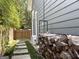 Side yard with wood pile, walkway, and fence at 10 Plum Blossom Ln, Hampton, GA 30228