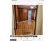Living room with hardwood floors and wood paneling at 6045 Winview Dr, Forest Park, GA 30297