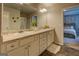 Double vanity bathroom with a large mirror and shower at 130 Bingley Ct, Covington, GA 30016