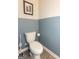 Small bathroom with toilet and blue accent wall at 4937 Lower Elm St, South Fulton, GA 30349