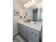 Modern bathroom with double vanity, gray cabinets, and a large mirror at 4937 Lower Elm St, South Fulton, GA 30349