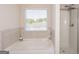 Relaxing bathroom with soaking tub, separate shower, and updated fixtures at 4937 Lower Elm St, South Fulton, GA 30349
