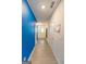 Long hallway with blue accent wall and light gray flooring at 4937 Lower Elm St, South Fulton, GA 30349