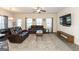 Spacious living room featuring comfortable reclining sofas, a large TV, and ample natural light at 4937 Lower Elm St, South Fulton, GA 30349