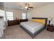 Bright main bedroom with a king-size bed, large windows, and plenty of dresser storage at 4937 Lower Elm St, South Fulton, GA 30349
