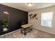 Home office with a desk, world map art, and a trendy wall color at 4937 Lower Elm St, South Fulton, GA 30349